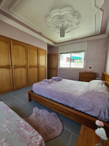 a bedroom with two beds and a window at Dar Babou in Rabat