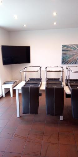 a conference room with tables and chairs and a flat screen tv at Harz meets friends in Hasselfelde