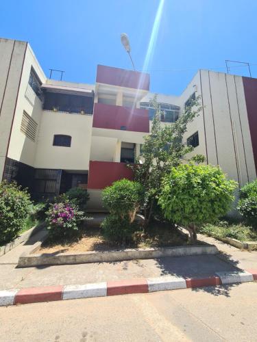 a building with trees and bushes in front of it at Dar Babou in Rabat