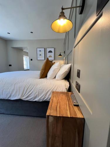 a bedroom with a bed and a wooden table at The Punchbowl Inn in Woodstock