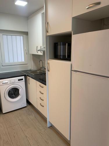 a kitchen with a refrigerator and a washing machine at Ducado 41 Playa in Benidorm