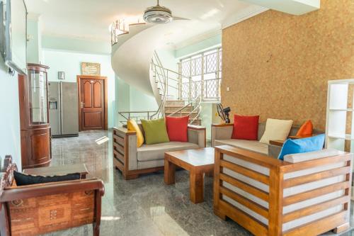 a living room with two chairs and a staircase at Asian Residencies - Grandpass in New Bazaar
