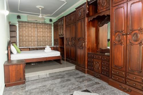 a bedroom with a bed and wooden cabinets at Asian Residencies - Grandpass in New Bazaar