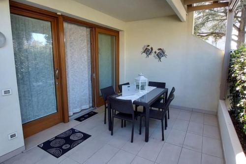 a dining room with a table and chairs on a patio at Residence Jesolo Lido centro con piscina in Lido di Jesolo