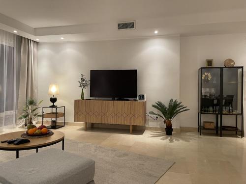 a living room with a flat screen tv on a wall at Oasis 3 bedroom Marbella Golden Mile in Marbella