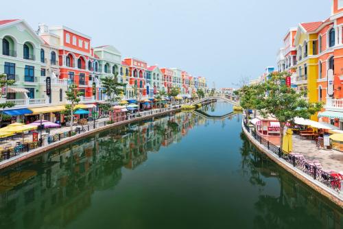 a river in a city with colorful buildings and a canal at Le Palmier Phu Quoc Hotel - Free Shuttle To Grand World in Phu Quoc