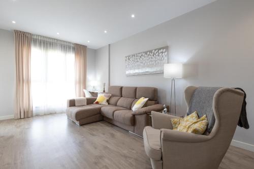 a living room with a couch and a chair at Los Alamos Beach Flat in Torremolinos