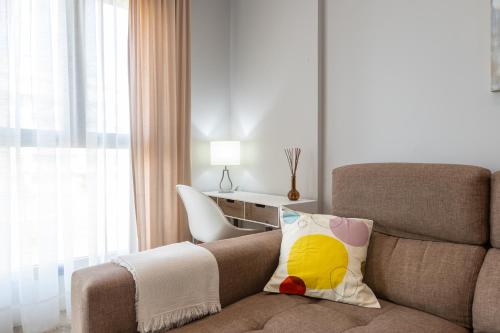 a living room with a couch and a chair at Los Alamos Beach Flat in Torremolinos