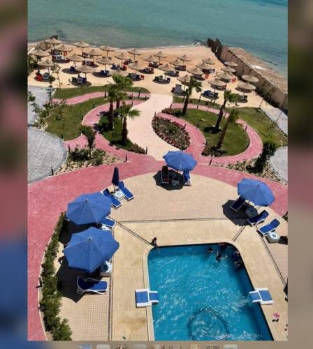 uma vista aérea de um resort com uma piscina e guarda-sóis em كازبلانكا بيتش الغرددقه em Hurghada