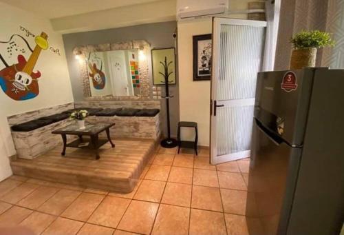 a living room with a refrigerator and a table at Athens Victoria's Apartment in Athens