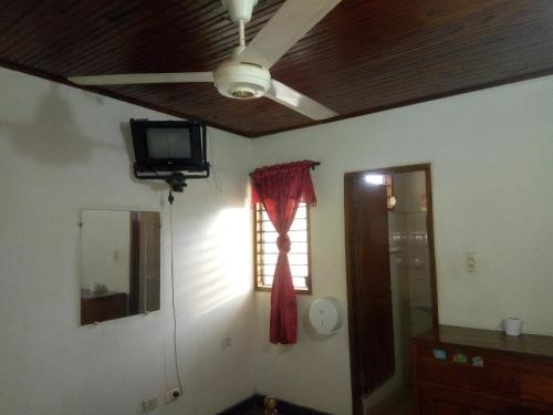 a living room with a ceiling fan and a window at HOTEL en MONTERIA CITY in Montería