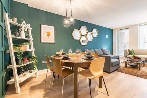 a dining room with a table and chairs and a couch at Cosy and modern Bedroom in the heart of Dublin in Dublin