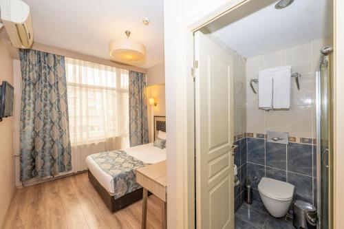 a small bathroom with a bed and a shower at Tugra Hotel in Istanbul