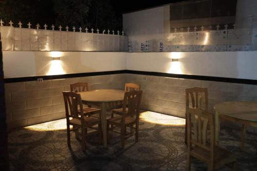 a dining room with tables and chairs and lights at Happiness Guest House in Luxor