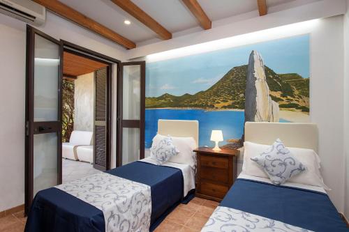 a bedroom with two beds and a painting on the wall at Hotel Rurale Orti di Nora & SPA in Santa Margherita di Pula