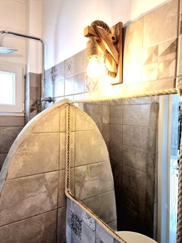 a bathroom with a shower with a toilet in it at Joannes Vacation Rooms in Adamas