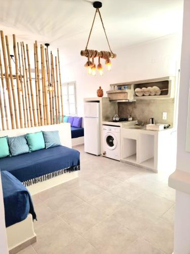 a living room with a bed and a kitchen at Joannes Vacation Rooms in Adamas