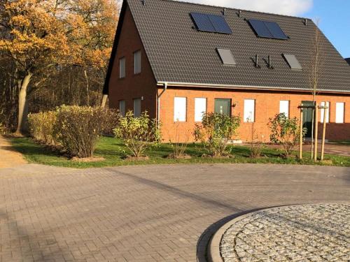 a house with solar panels on top of it at Ferienhaus Im Honigdorf in Wietzendorf