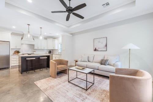 a living room with a couch and a table at Charming Cottage built in 2019 in Lafayette