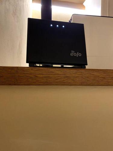 a flat screen tv sitting on top of a wooden shelf at Casa di Adele in Pratovecchio
