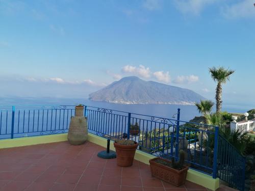 a balcony with a view of a mountain and the ocean at Villa Panorama in Lipari