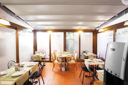a room with tables and chairs in a restaurant at Hotel Piazza Di Spagna in Rome