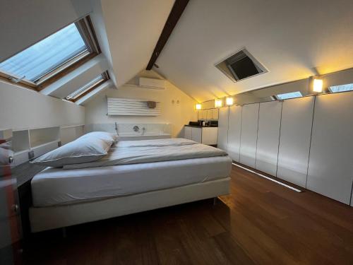 a bedroom with a large bed and a window at W Y C K - E N D boutique b&b in Maastricht