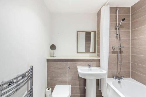 ein Badezimmer mit einem Waschbecken, einem WC und einer Badewanne in der Unterkunft Stylish 1 Bedroom Apartment by BOLD Apartments in Liverpool