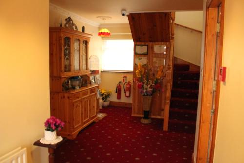 a room with a staircase and a room with a stair case at Seacourt Accommodation Tramore - Adult Only in Tramore