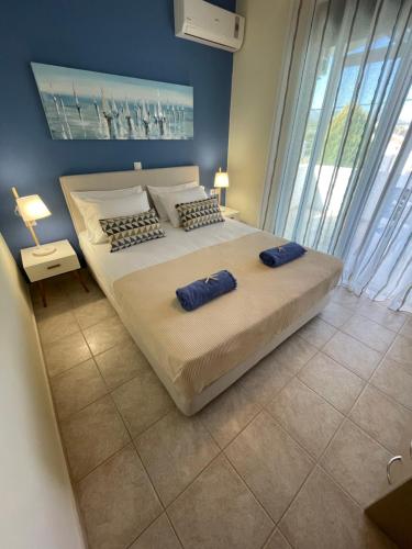 a bedroom with a large bed with two pillows on it at Sunny Villa in Kissamos