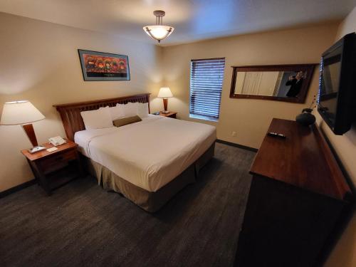a hotel room with a bed and a television at Villas of Sedona, a VRI resort in Sedona
