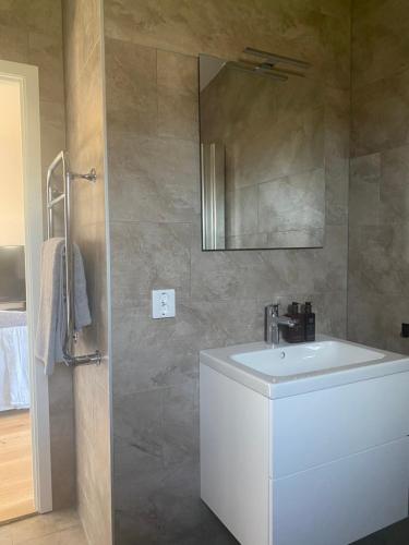 a bathroom with a sink and a mirror at Monsunen in Sölvesborg