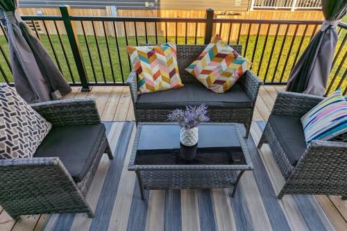 a patio with two chairs and a coffee table on a deck at Subu's Paradise in Niagara in Niagara on the Lake