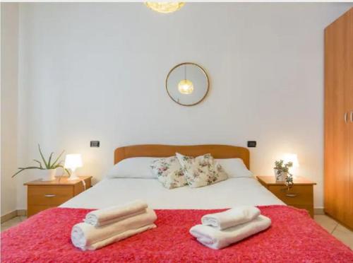 a bedroom with a bed with two towels on it at Casa Ulivi Rosso in Rivoltella