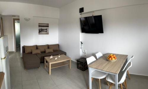 a living room with a couch and a table at Bouvegio Apartments Vera in Afantou