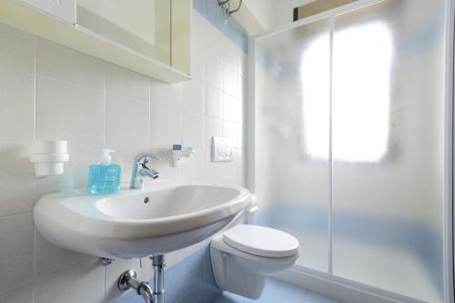 a bathroom with a sink and a toilet and a shower at Apartment in Lignano 21638 in Lignano Sabbiadoro