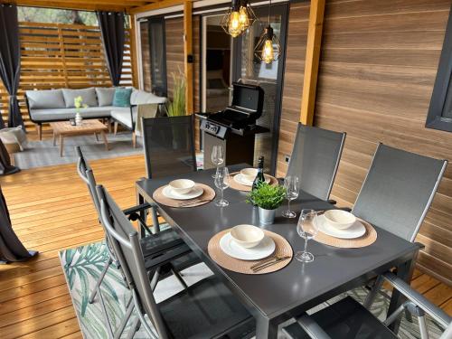 a dining room with a table and chairs at Mobile Homes MaLu in Biograd na Moru