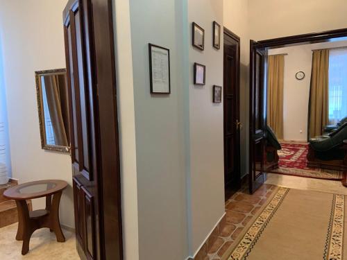 a hallway with a door leading to a living room at Hetman Hotel in Kamianets-Podilskyi