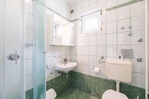 a bathroom with a toilet and a sink at One-Bedroom Apartment in Crikvenica XI in Dramalj