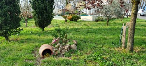 a pile of logs in the grass in a yard at Oltre la Siepe Apartment in Nepi