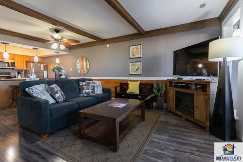 a living room with a couch and a table at 2BR Walk-In Condo - Near the 76 Strip - Pool - FREE TICKETS INCLUDED - CLA-8 in Branson