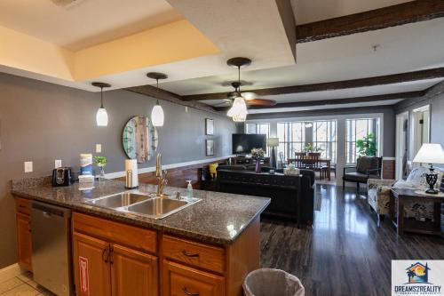 a kitchen with a sink and a living room at 2BR Walk-In Condo - Near the 76 Strip - Pool - FREE TICKETS INCLUDED - CLA-8 in Branson