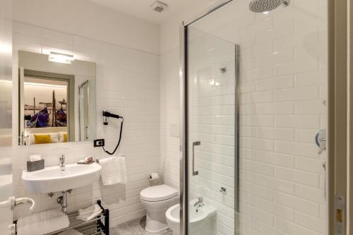 a bathroom with a toilet and a sink and a shower at Vatican Cozy Suites - Liberty Collection in Rome