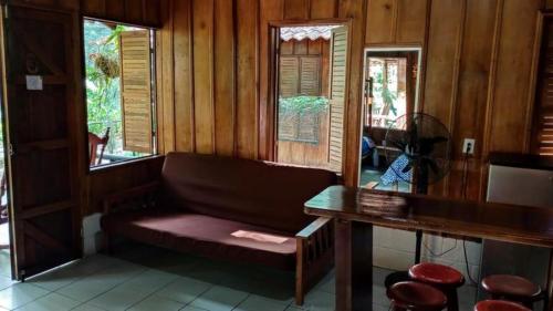 a room with a couch and a table and windows at Recreo Verde Hot Springs & Spa in Marsella