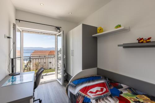a bedroom with a bed and a view of the ocean at Apartments Petra in Bol