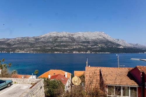 a view of a large body of water with a mountain at Long View Apartment, Korčula in Korčula