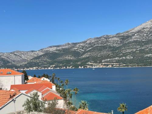 a view of a large body of water with mountains at Long View Apartment, Korčula in Korčula