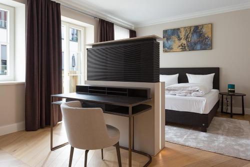 Schlafzimmer mit einem Bett und einem Schreibtisch mit einem TV in der Unterkunft Luxury Home / 2-Raum-Apartment an der Frauenkirche in Dresden