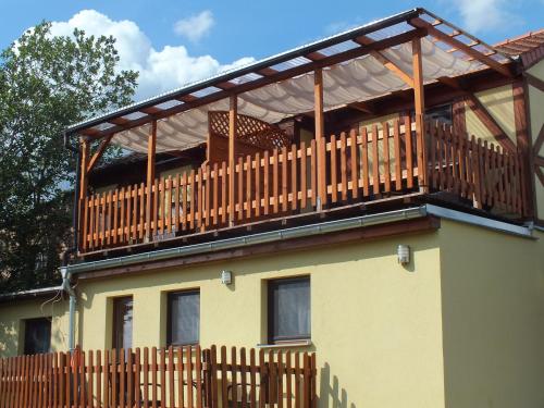 a wooden deck on top of a house at Pension am Elberadweg in Radebeul