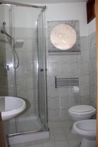 a bathroom with a shower and a toilet and a sink at Il Fascino del Borgo 2 in Castellabate